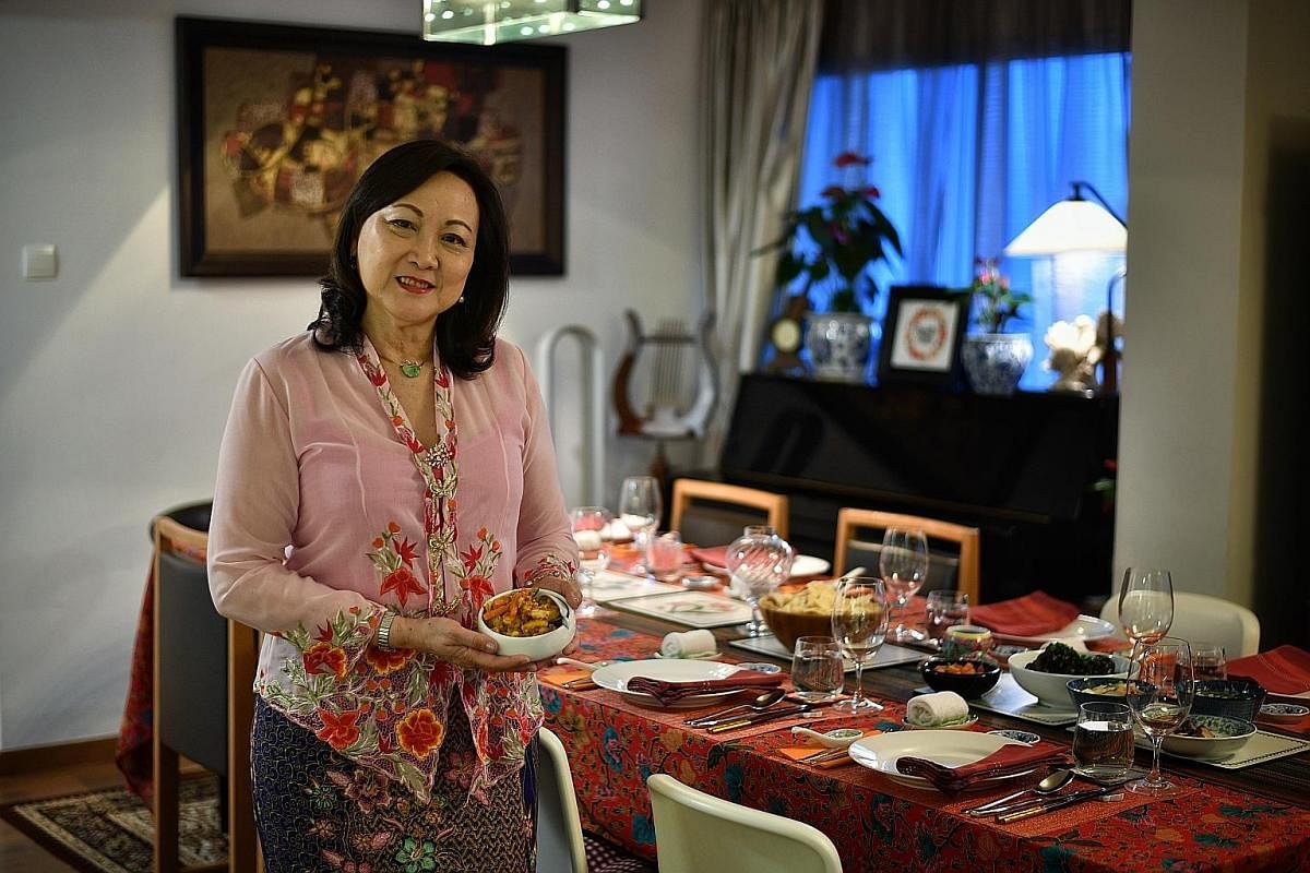 Lynnette Seah (seen with her achar, or pickled vegetables) serves Peranakan and Western meals in her flat in Tiong Bahru.