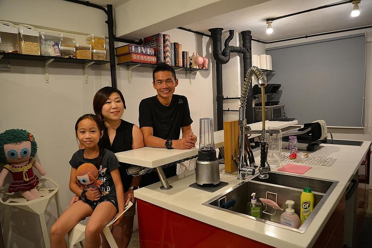 At the home of Mr Gordon Koh (top, with his wife Angelyn Han and daughter Capucine), the open kitchen (above) helps free up space for the home gym in the living room.