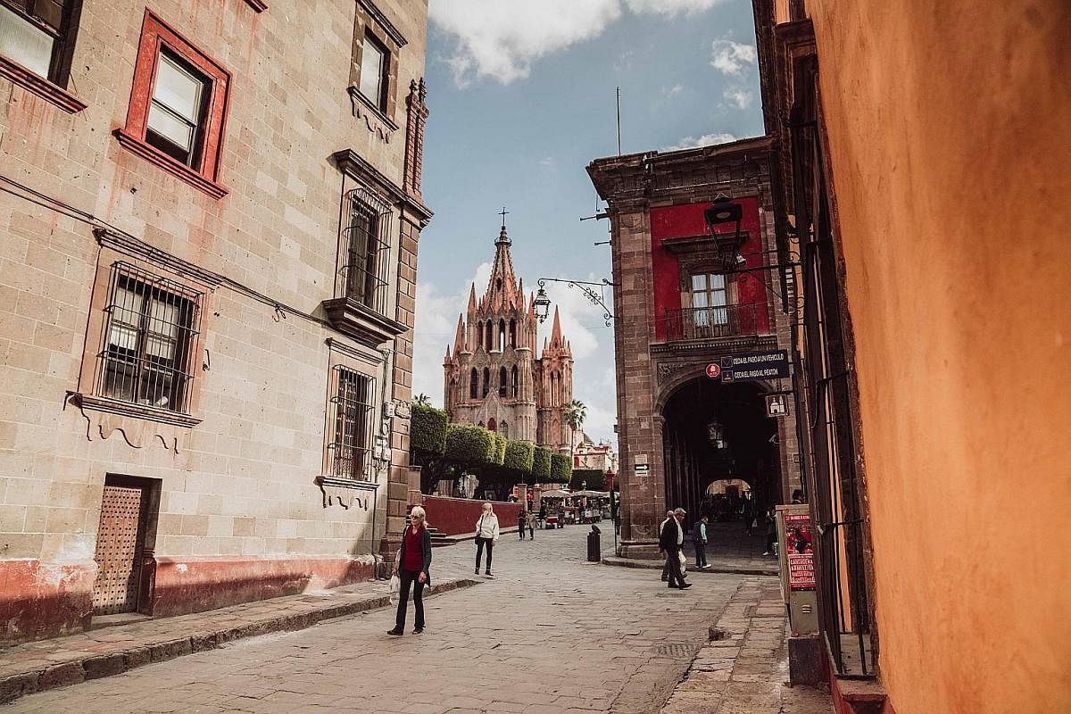 The bohemian city of San Miguel de Allende and its fairy tale-like church, Parroquia de San Miguel Arcangel (centre).