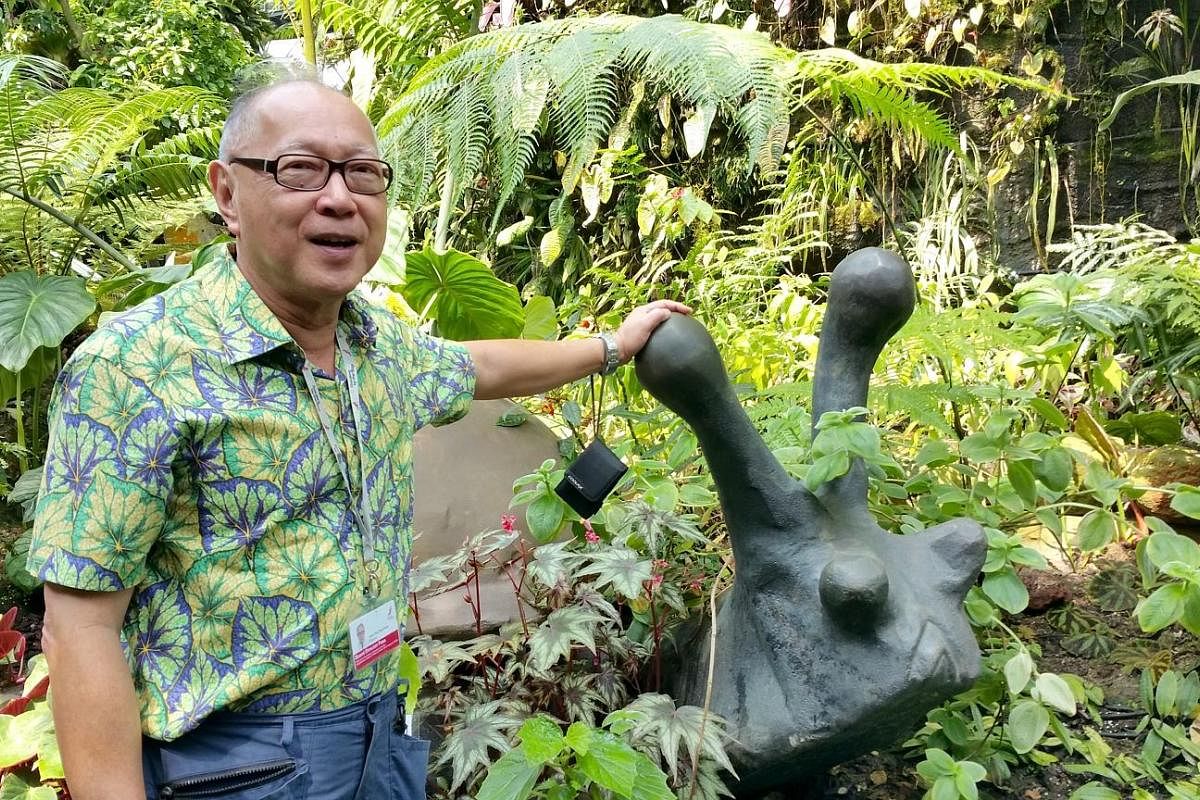 Mr Tan Jiew Hoe in 2015 with a bronze snail (above) he donated to Gardens by the Bay; and the first successful hybrid of the Corpse Flower, named Amorphophallus "John Tan" (right), blooming at Gardens by the Bay in September 2013.