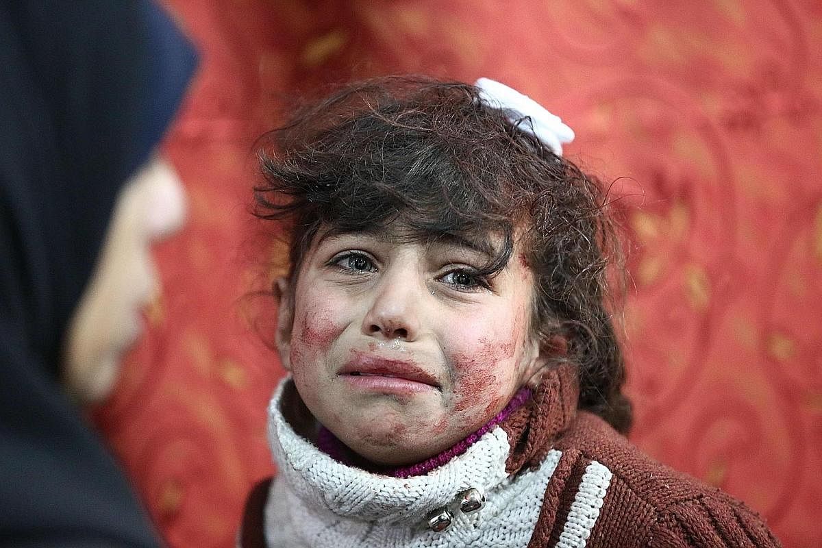 A boy being treated following a suspected gas attack on al-Shifunieh village. More than 18 people were affected and one child was killed. Nine-year-old Hala is among the civilians caught in the crossfire after a Syrian government air strike on the to
