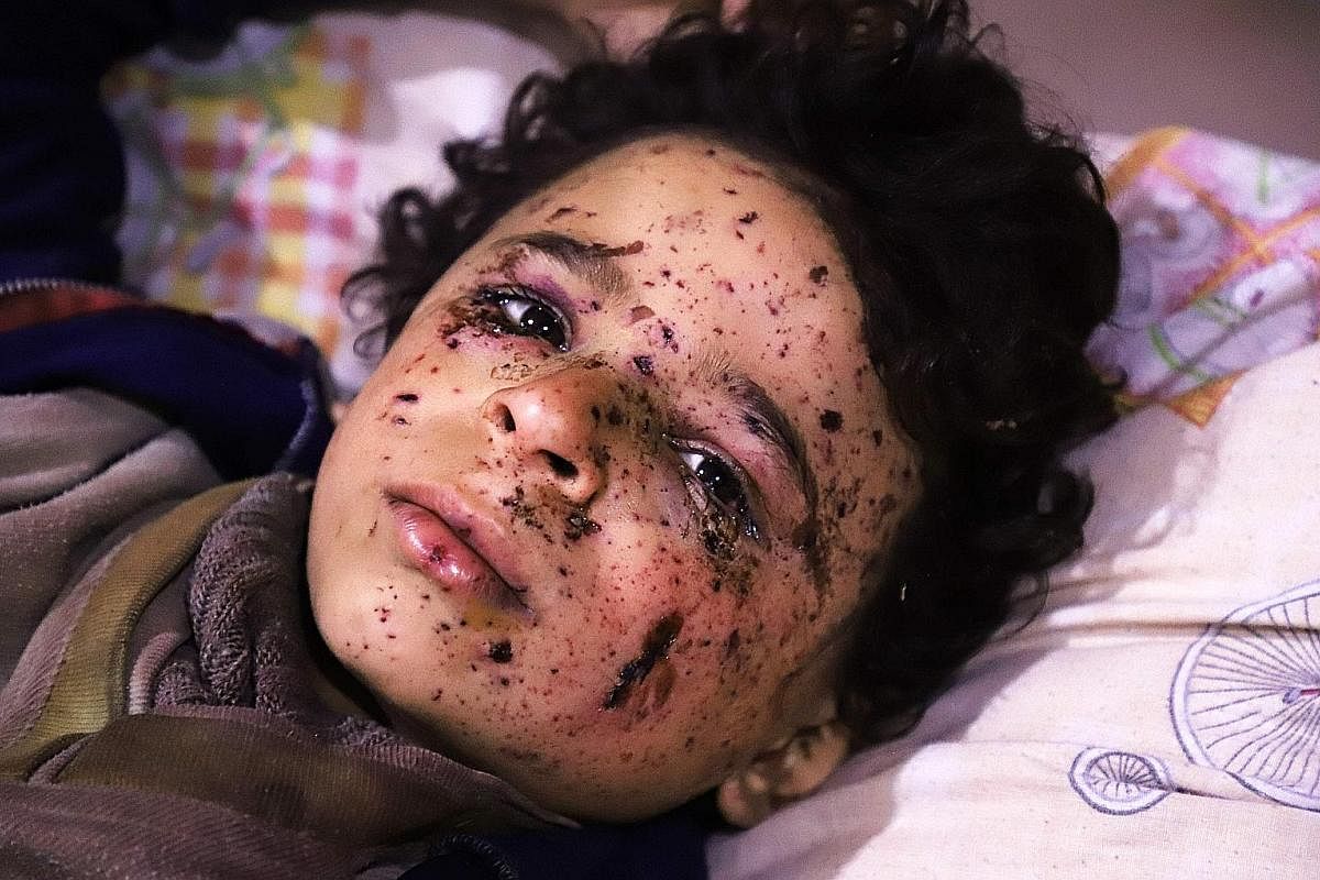A boy being treated following a suspected gas attack on al-Shifunieh village. More than 18 people were affected and one child was killed. Nine-year-old Hala is among the civilians caught in the crossfire after a Syrian government air strike on the to