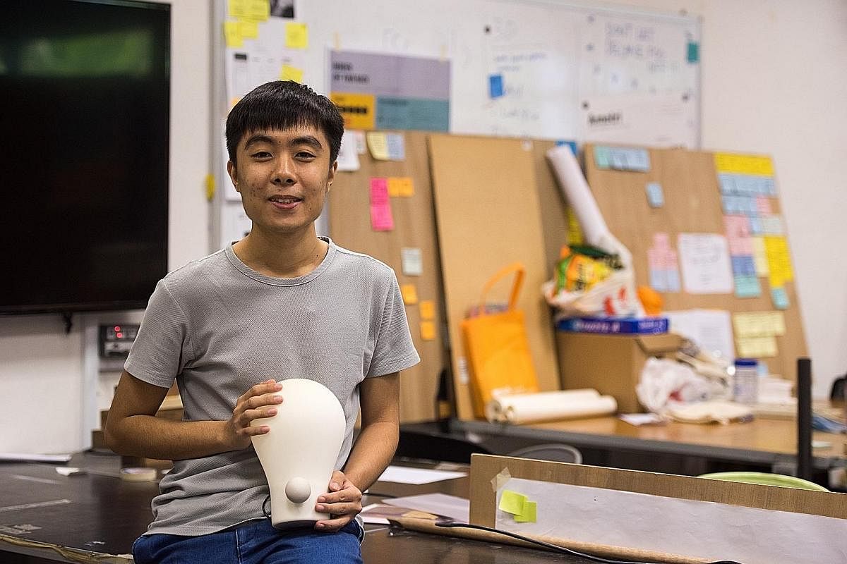 Mr Edmund Zhang with his Squeezy Lamp, which lights up when the user squeezes its ball-shaped knob in a series of pumping motions.