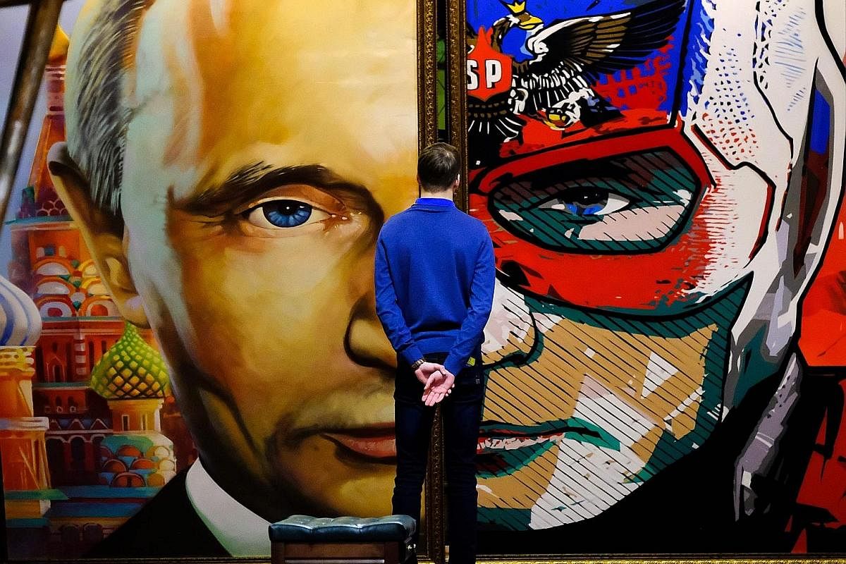 Campaign activists verifying signatures in support of Mr Putin as a candidate at his election campaign office in Moscow in January. On display at the SUPERPUTIN exhibition in Moscow's UMAM museum is this painting depicting "superhero" Russian Preside