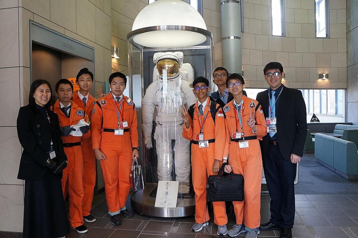 NUS High School students (in orange, from left) Fu Tianyi, 14, Kim Yongbeom, 15, Paul Seow Jian Hao, 14, Srivathsan Ram, 14, and Alexander Goo Zong Han, 14, after a mock astronaut training exercise. With them are Singapore Space and Technology Association