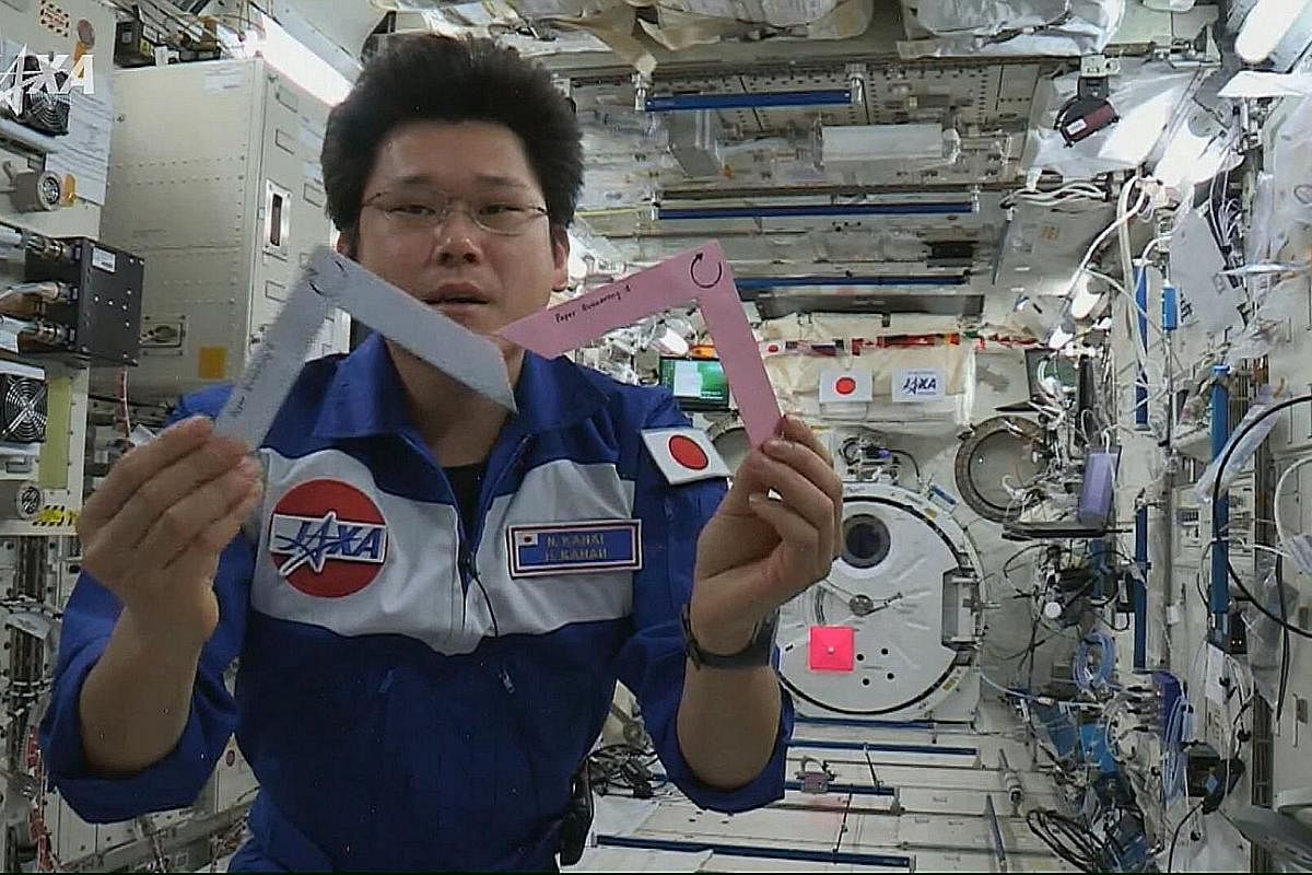 Dr Norishige Kanai performing the boomerang experiment conceived by NUS High School of Mathematics and Science students, on board Japan's module at the International Space Station known as Kibo, or "hope" in Japanese. The students had asked: Will a boomer
