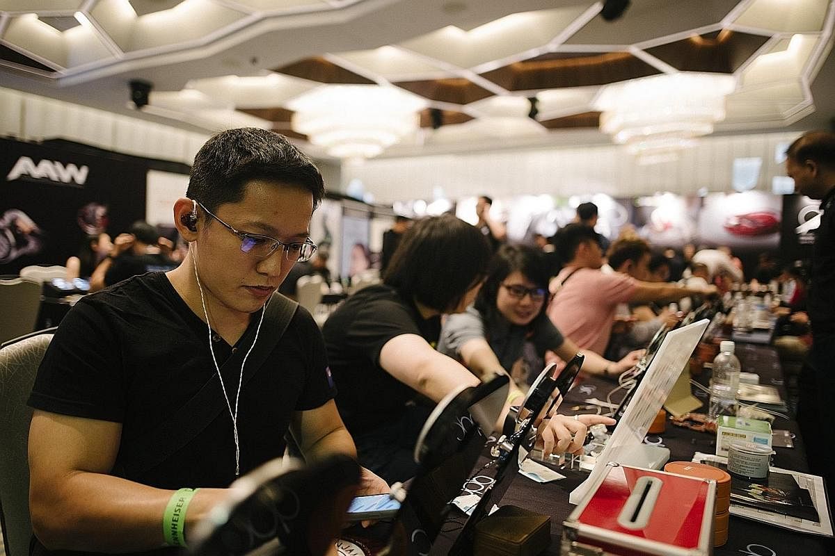 Audiophiles trying out headphones and audio set-ups at CanJam Singapore, held at Pan Pacific Singapore hotel over the weekend.