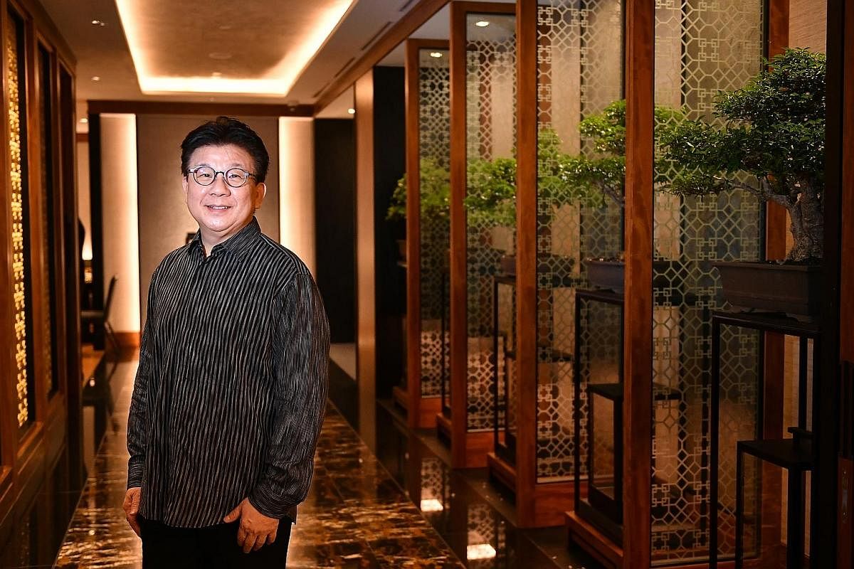 Private dining nooks are easily created by drawing the curtains at Hua Ting Restaurant (above), whose interior was redesigned by Mr William Ong (left).
