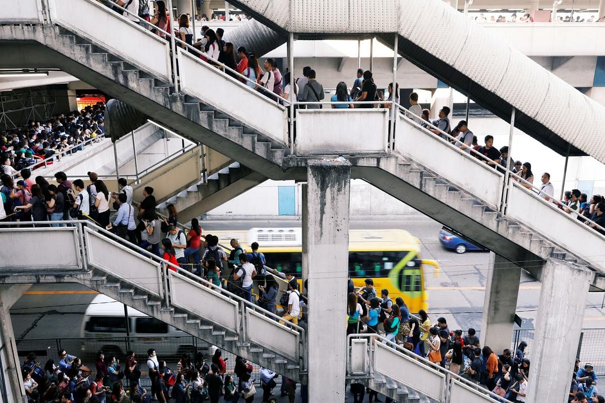Commuters waiting to take the Metro Rail Transit during morning rush hour in North Avenue, Quezon City, part of Metro Manila. The rail system is already showing its age, says the writer. Heavy traffic in Makati City south of Manila, the densely popul