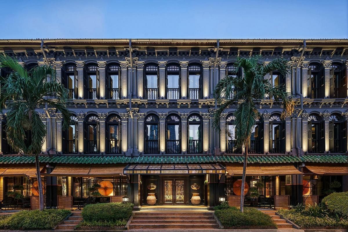 While no structural changes were made to the hotel (right), the interior's traditional Chinese elements and black, yellow and gold palette (left) hark back to the days when opium dens lined Duxton streets.