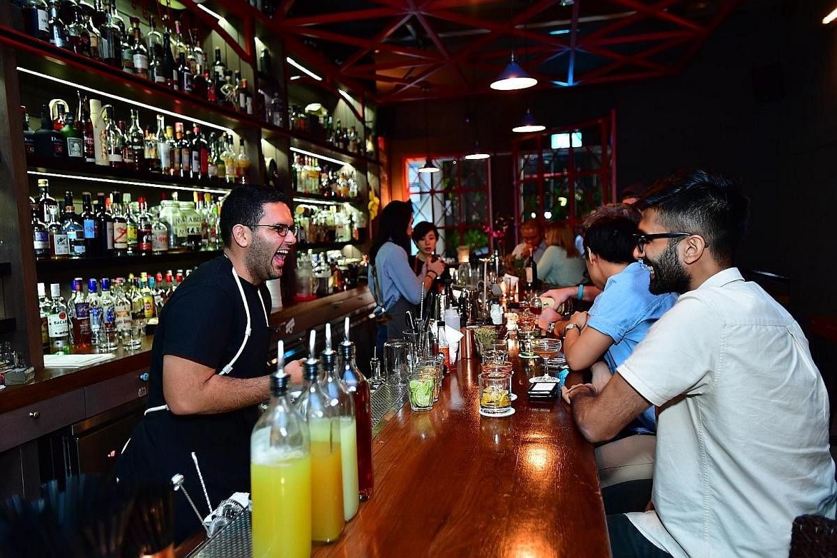 Customers sampling cocktails at a participating bar at last year's Singapore Cocktail Festival.
