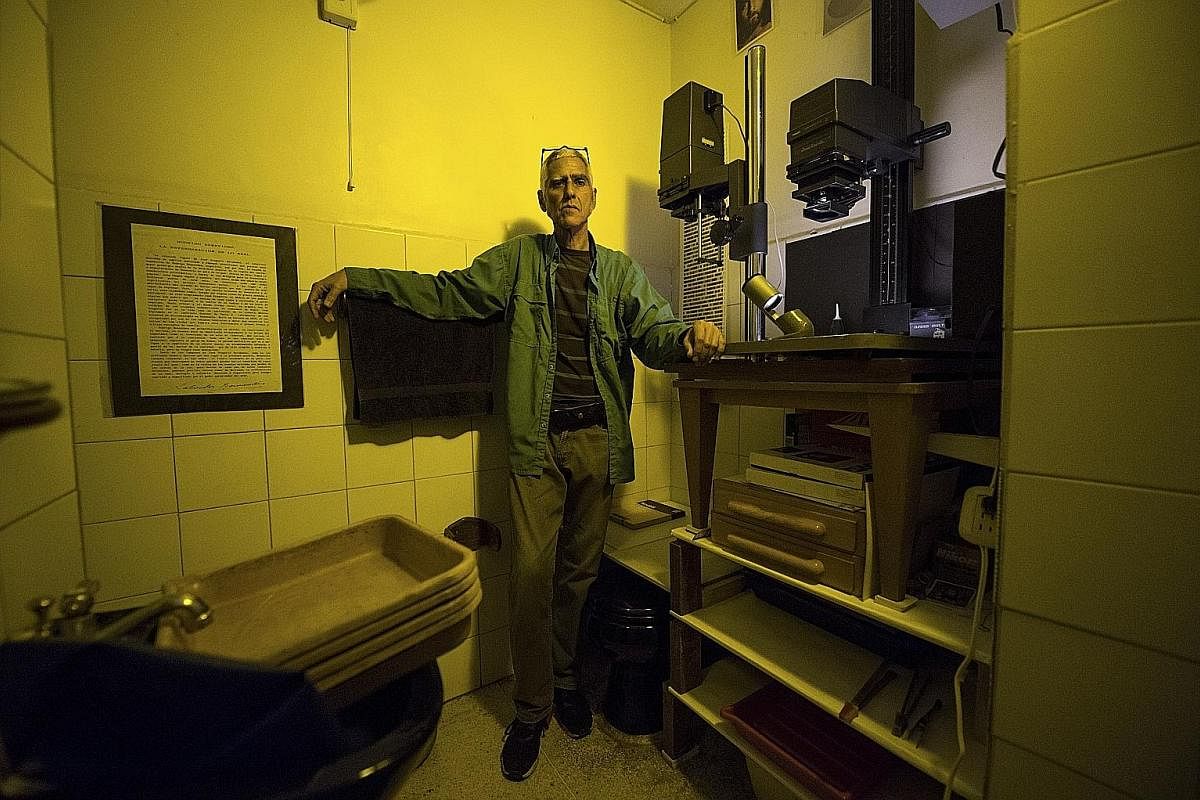 Photographer Rodrigo Benavides from Venezuela has created a makeshift lab in a bathroom in his home, in Caracas, which he uses to develop black-and-white prints from negatives. Mr Mohammad Ashgar, 65, with his rickshaw in Kolkata, India. The rickshaw