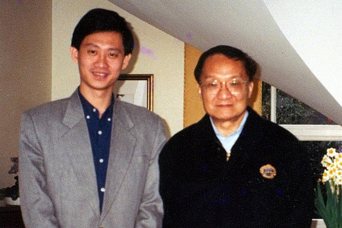 Comic artist Wee Tian Beng (left) with legendary Chinese writer Louis Cha, or Jin Yong, whose Return Of The Condor Heroes he illustrated in the late 1990s, at Cha's house. Wee (right), in his 20s, with his fellow aspiring comic artists (from left) Ta