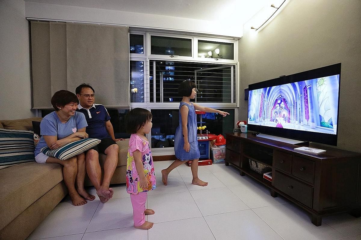 Stay-at-home mum Cecilia Eow, her husband Augustine Tai and their daughters, Lydia and Angeline, watching My Little Pony during a movie night at home. Mr Michael Buyung Santoso Raditya and his wife Pee Lean Choo prefer that their son Kairos watch car