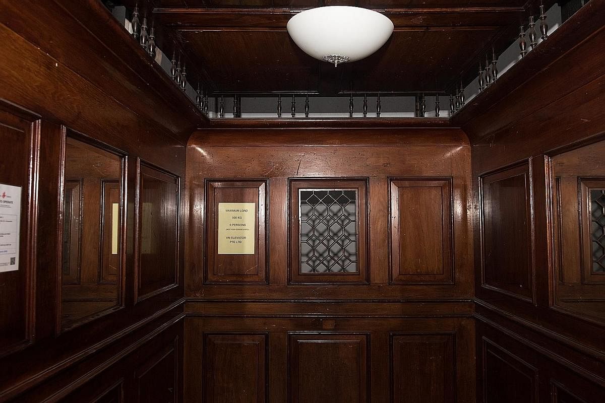 The lift, which was built and installed by British company Smith, Major and Steven, has (from left) wooden panelling, a collapsible iron gate and steel weights. The building was Singapore's first Modernist building. The building at 5 Kadayanallur Str