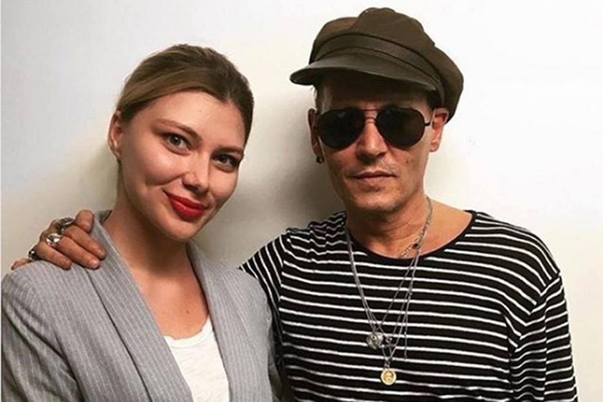 Actor Johnny Depp (above, with a fan) was in Russia as part of a two-month worldwide tour with his rock band Hollywood Vampires.