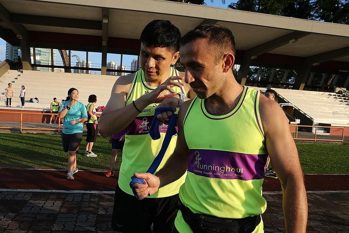 Living up to Runninghour's motto of "Run to bond, run so others can!", polytechnic lecturer and running guide Wang Cuiling and visually-impaired office worker Fadiah Aman have been doing just that together for the third time. Here they are seen compl