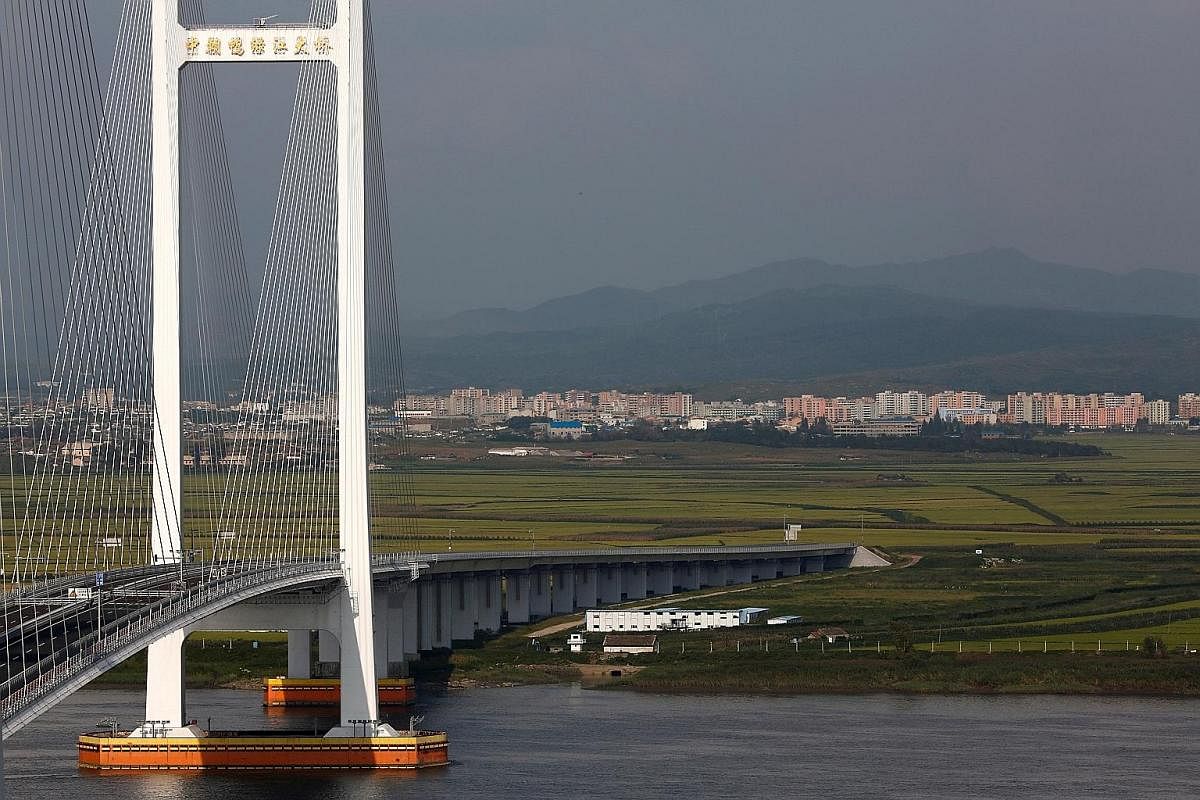 North Korea as seen from the Chinese border city of Dandong, separated by the Yalu River. Dandong residents are hopeful the city's fortunes, which are very much tied to North Korea, could rise again. Border trade has been hit hard by United Nations s