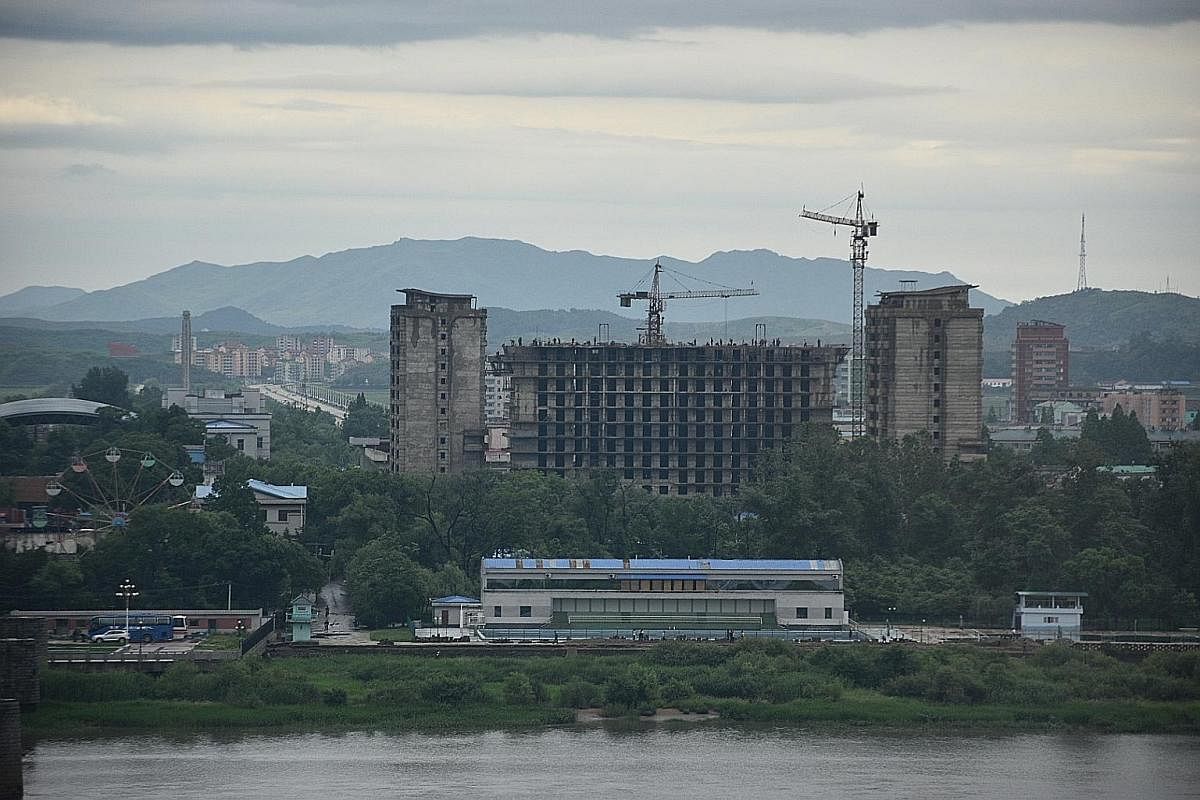 North Korea as seen from the Chinese border city of Dandong, separated by the Yalu River. Dandong residents are hopeful the city's fortunes, which are very much tied to North Korea, could rise again. Border trade has been hit hard by United Nations s