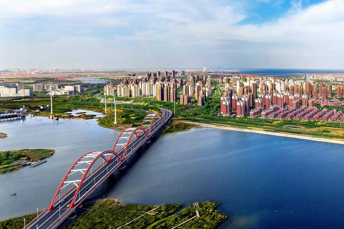 The eco-city last year, after the bilateral project turned the barren wasteland into a thriving township that emphasises a low-carbon, green lifestyle. The approach to Tianjin Eco-city from the Rainbow Bridge in the Tianjin Binhai New Area in 2008, b