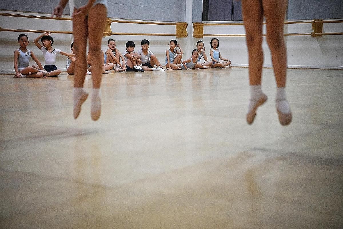 Students are seen through the hallway of the Singapore Ballet Academy as they train during a youth group night class. The oldest ballet academy in Singapore was first housed in Kay Lee Road in 1958 and moved a few more times before settling in at Wat