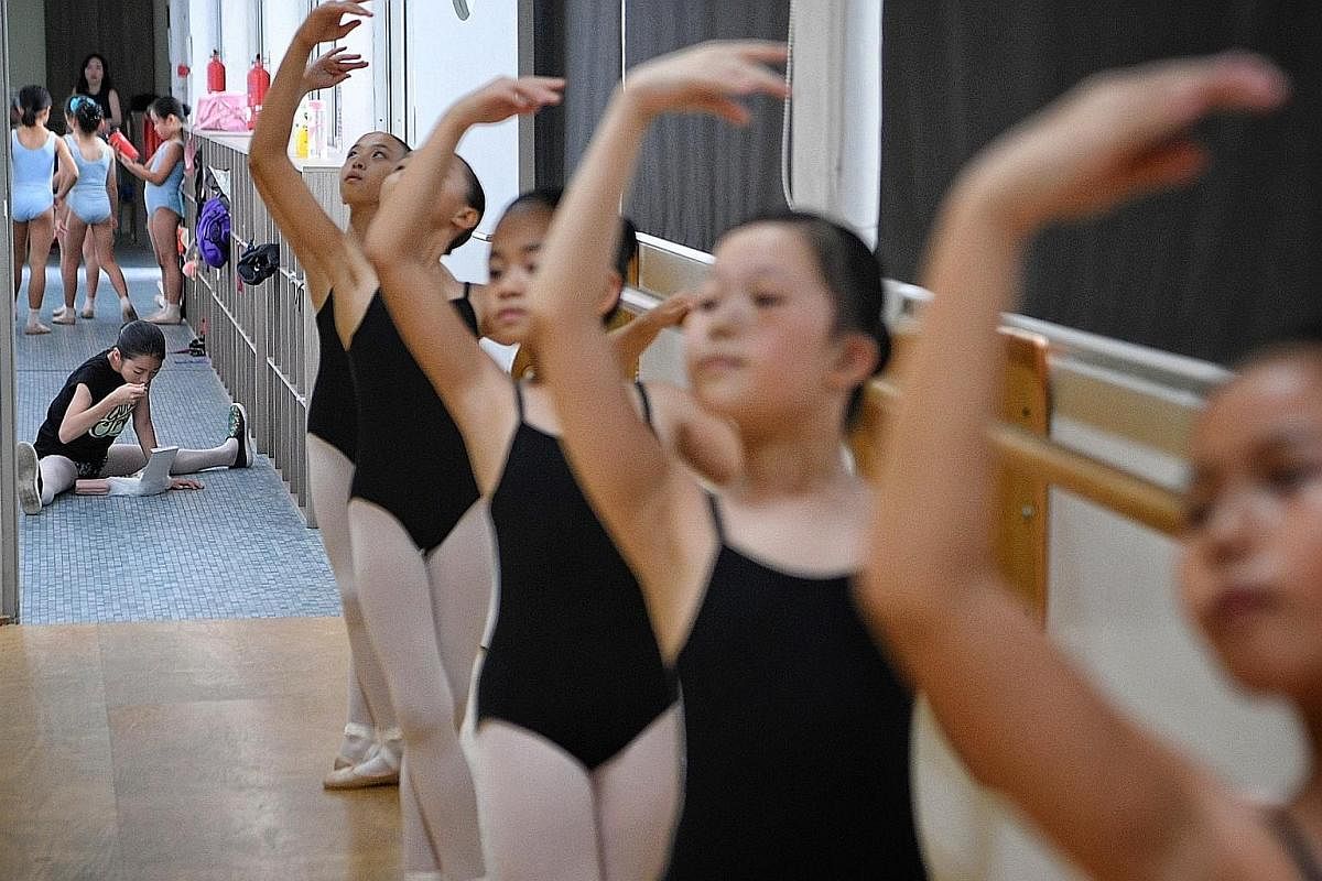 Students are seen through the hallway of the Singapore Ballet Academy as they train during a youth group night class. The oldest ballet academy in Singapore was first housed in Kay Lee Road in 1958 and moved a few more times before settling in at Wat