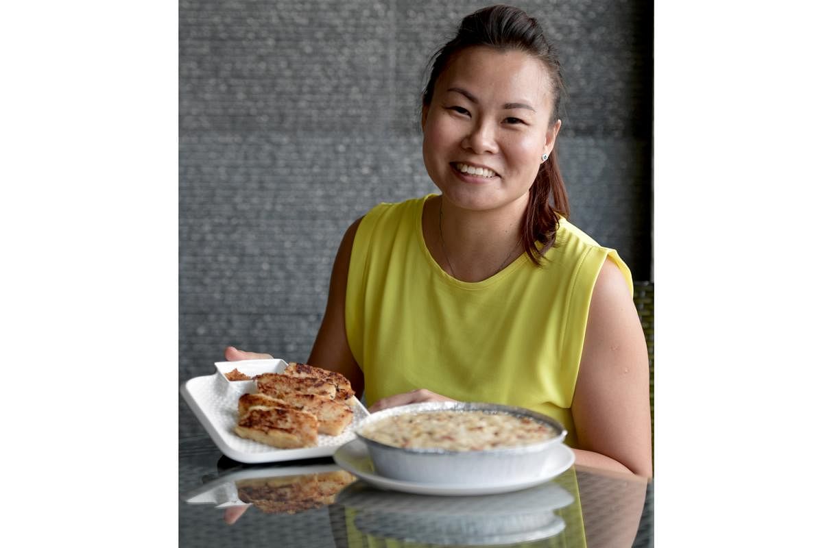Ms Kelly Pang with the two versions of her radish cake - the steamed one (right) has a light and fluffy texture, while the fried one is soft inside with a crisp exterior.
