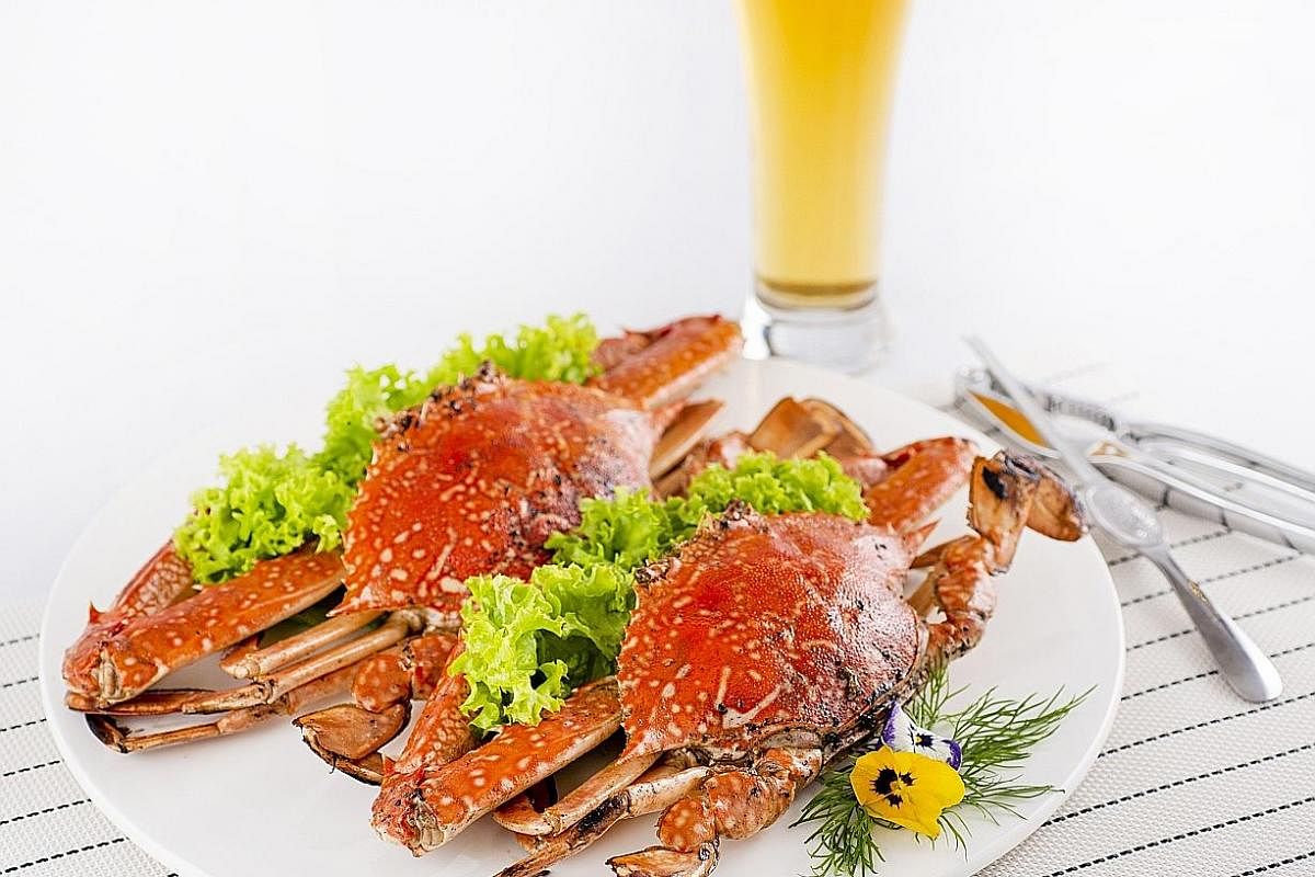 The Baked Flower Crab With Rock Salt (right) has sweet, firm meat enhanced by salt and pepper on the shells and the Crystal Chicken (left) is tender and juicy.