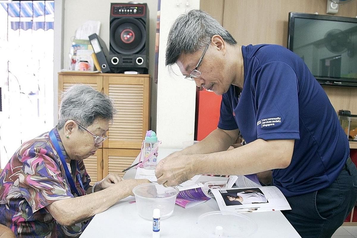 Sales manager Eric Tan volunteers at a seniors activity centre at Block 35 Circuit Road every Saturday for at least four hours. Administrative assistant Deborah Ong and Ms Judith Teo, one of the programme's beneficiaries, learning aboutroad signs and