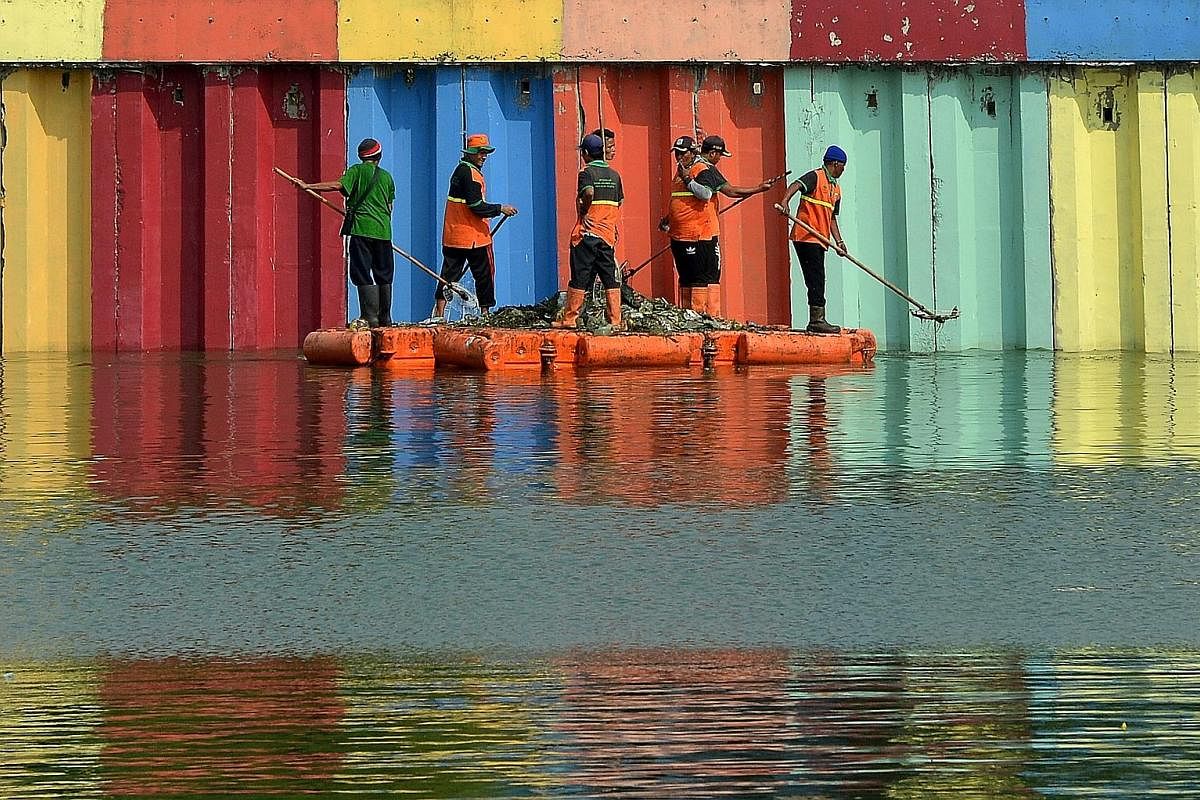 Helping Jakarta make a good impression is an army of sanitation workers known locally as Pasukan Oranye, or the Orange Force, so called because of the colour of their uniforms and vehicles. Pasukan Oranye workers cleaning Lake Sunter in North Jakarta