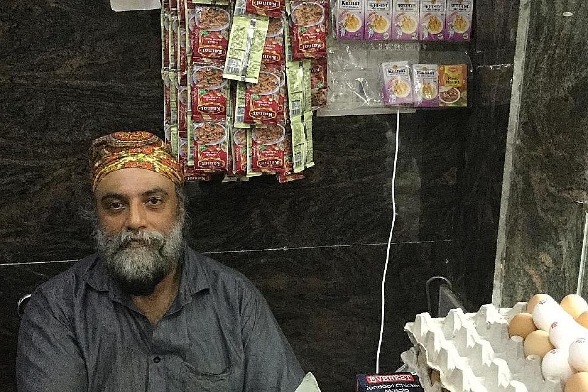 Top: Mr Ranjit Singh came to India in 1992 and applied for citizenship in 2007. He is still waiting to get it. Above: Mr Jagmohan Singh Gaba at his meat shop in Delhi's Krishna Park neighbourhood. He applied for citizenship eight years ago and has ye
