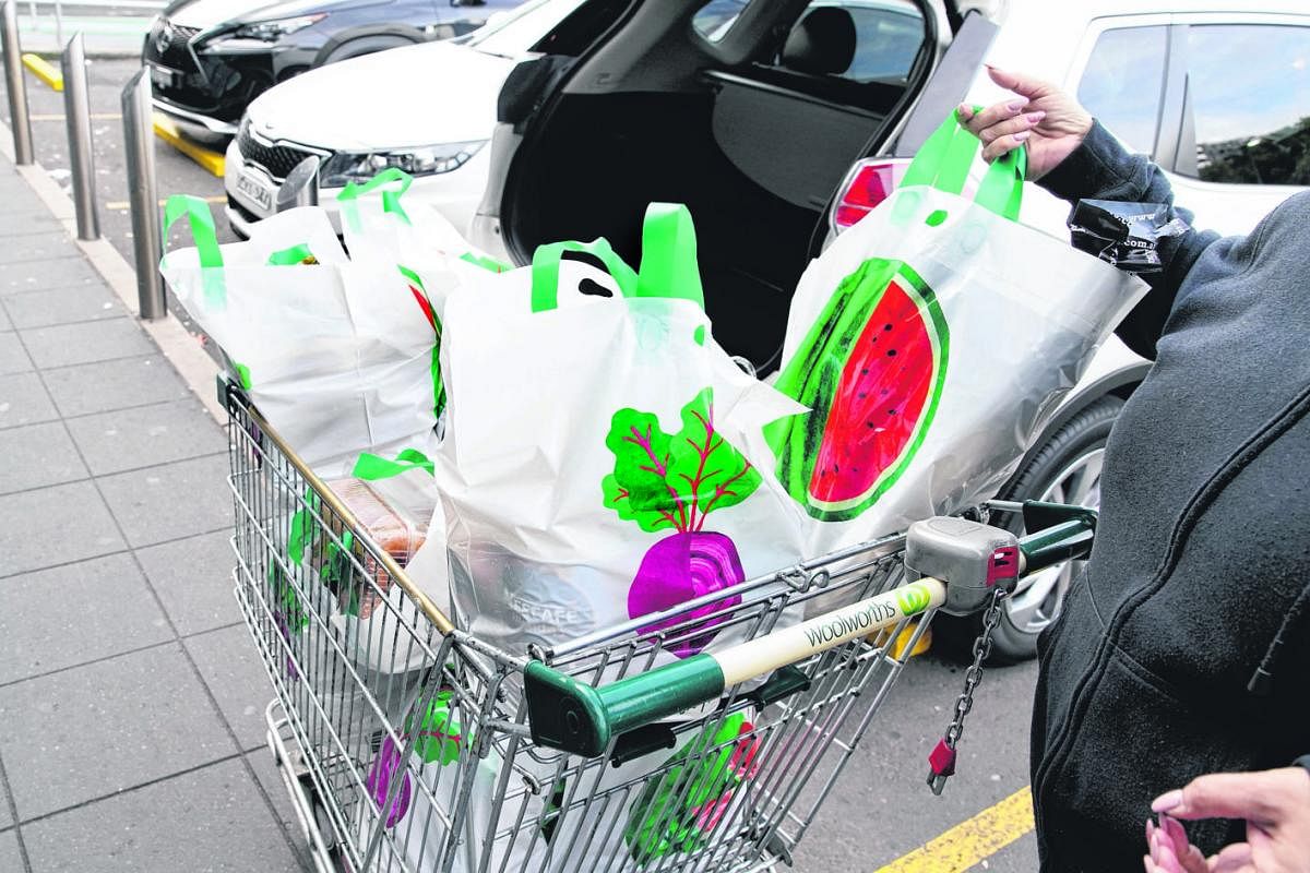 A shopper unloading reusable plastic bags provided by supermarket chain Woolworths in Sydney last month. The chain's ban on single-use bags prompted anger among consumers, who claimed to be unprepared.