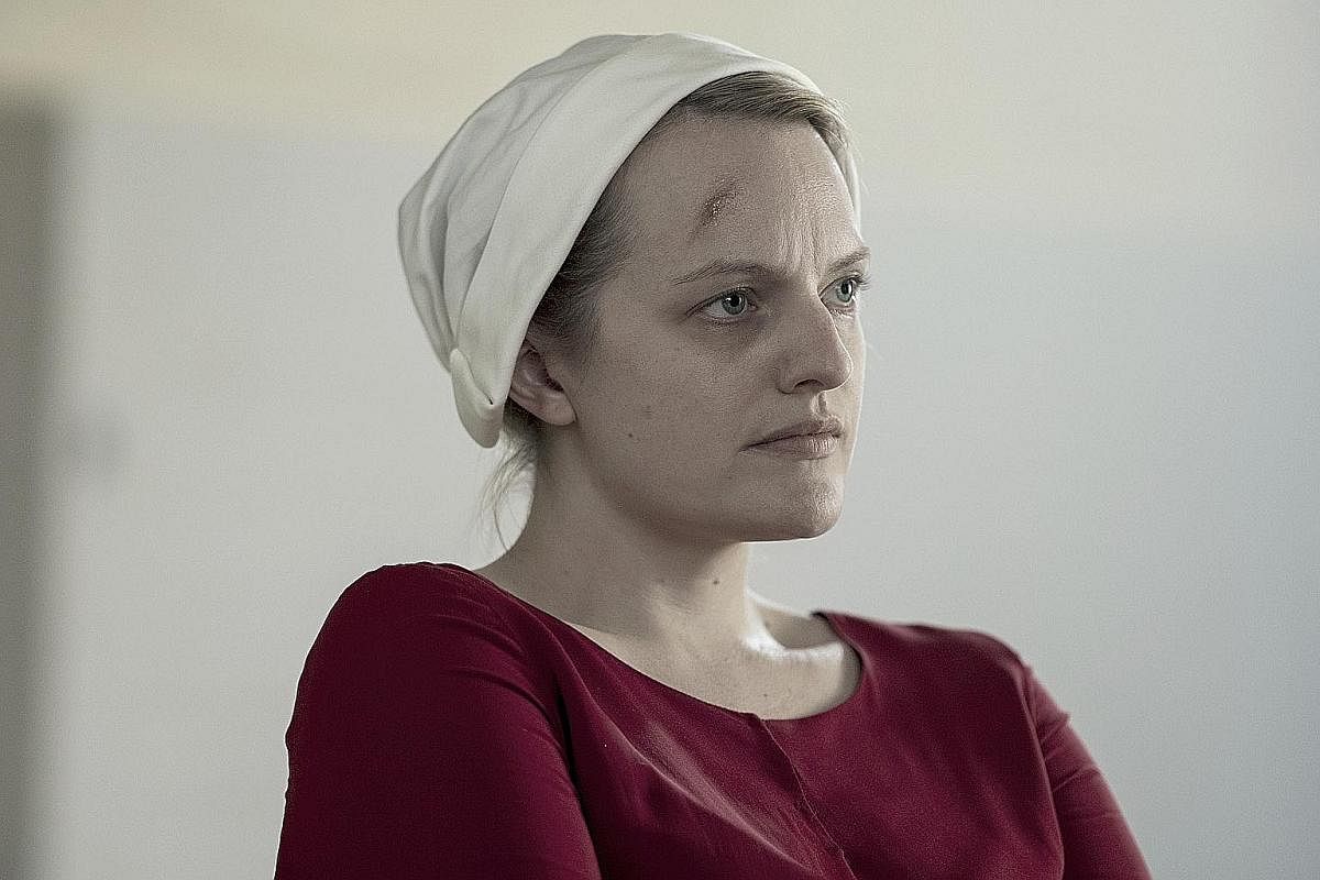 Actress Elisabeth Moss (above) in The Handmaid's Tale. A co-producer of the series, she and show creator Bruce Miller (both left), won the Golden Globe for Best Television Series Drama earlier this year.