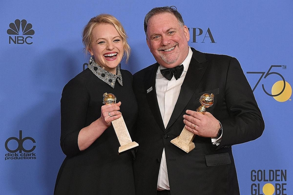 Actress Elisabeth Moss (above) in The Handmaid's Tale. A co-producer of the series, she and show creator Bruce Miller (both left), won the Golden Globe for Best Television Series Drama earlier this year.