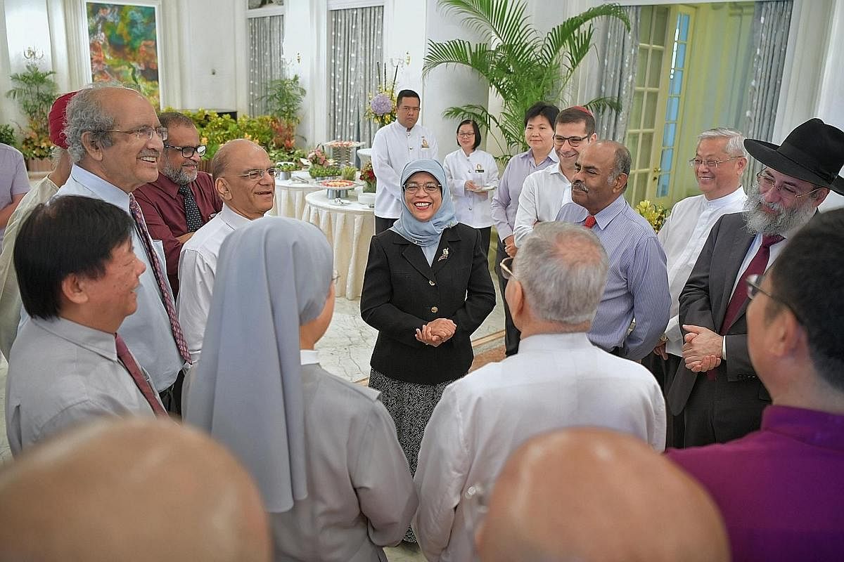 President Halimah with members of the Inter-Religious Organisation at a buffet brunch in the Istana's Reception Room on Sept 28 last year. With the President are (clockwise from centre left) Sister Theresa Seow (back facing camera), Mr Kuek Yi Hsing,