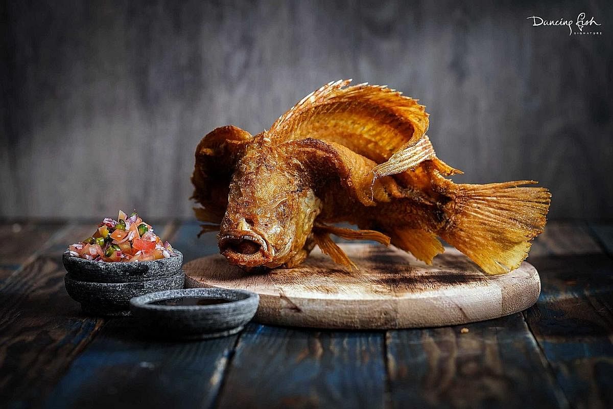 The signature dish is a tilapia sliced lengthwise, but with the fillets still attached to its head, which makes the meat curl up when it is deep fried.
