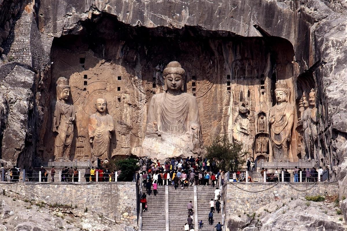 Fengxian Temple (left), a cluster of nine massive sculptures spread out across a 40m niche, is the piece de resistance of the Longmen Grottoes (above). The Tiantang hall (above) was used for religious ceremonies and stands at an auspicious 88.88m, th