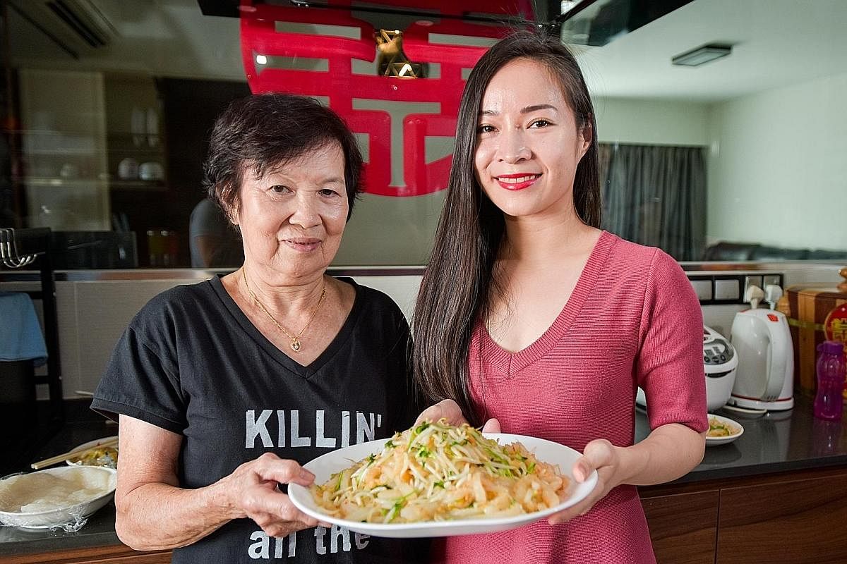 (Clockwise from top left) Tapioca starch in a bowl, dried prawn with garlic and chilli, cookbook, porridge cake strips and a plate of coriander and bean sprouts. Lace Zhang with her grandmother, Madam Ong Keow Lan, whom she learnt to cook porridge ku