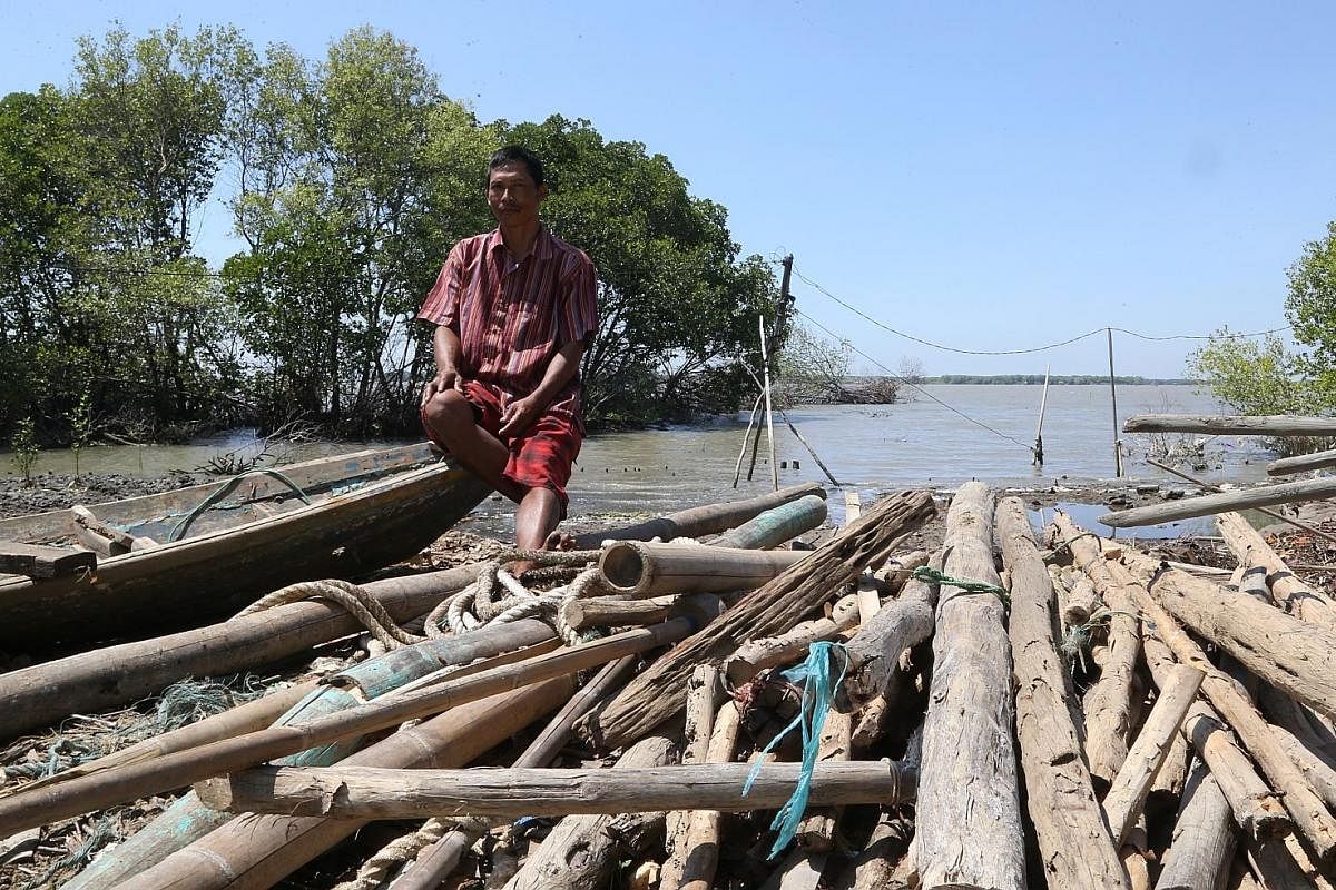 Residents from the now underwater eastern part of Pantai Bahagia village in Bekasi district, just outside Jakarta, moved to the northern and western parts and built elevated bamboo pathways. These pathways become most useful when the water rises to i