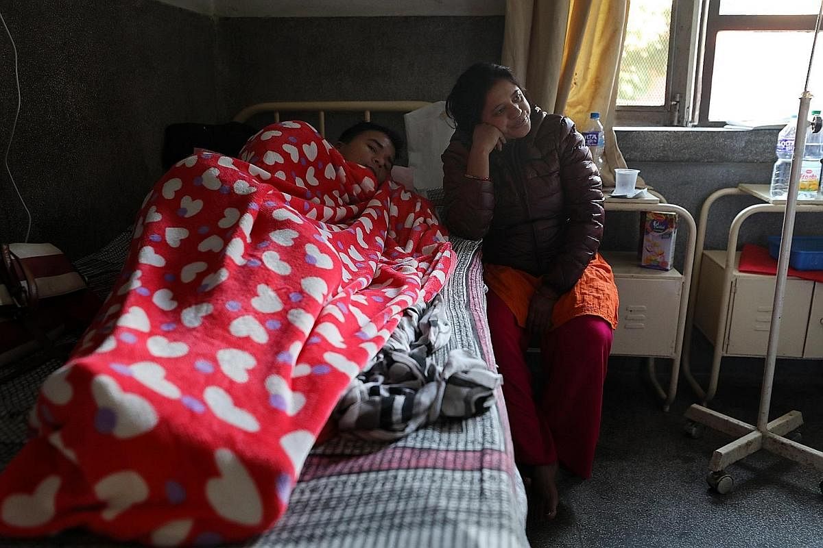 Dengue patient Kul Bahadhur Poudel, 33, with his wife Saradha at the Sukraraj Tropical and Infectious Disease Hospital in Kathmandu. Large dengue outbreaks have hit Nepal every three years like clockwork. Ratnanagar near Bharatpur in Nepal experience