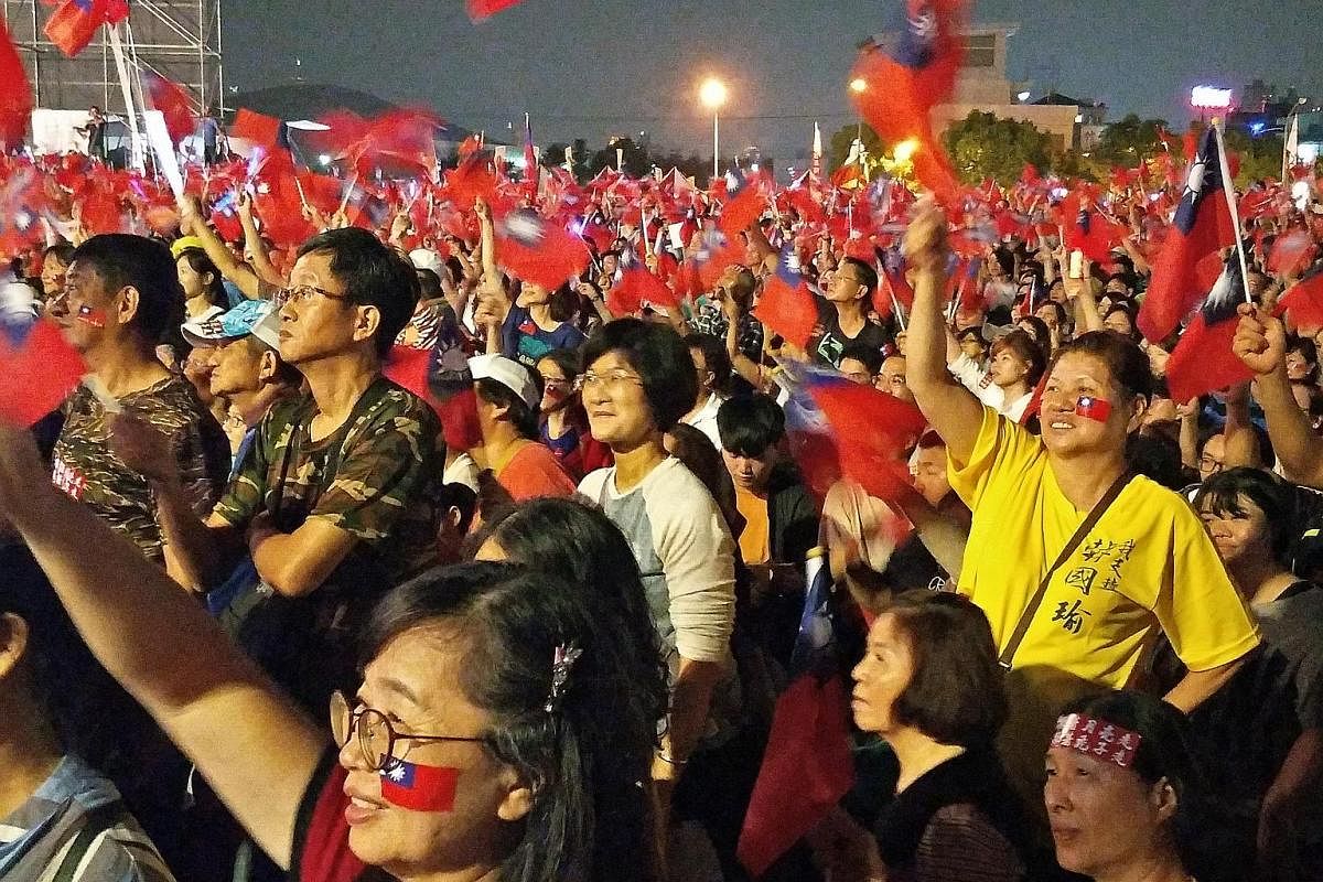 An estimated 120,000 supporters of Taiwan's latest political star, Mr Han Kuo-yu, waving the island's blue-and-red flags in a campaign rally last night. The crowd blew horns and shouted "dong suan! dong suan! (elected, elected!)" as Mr Han, a 61-year