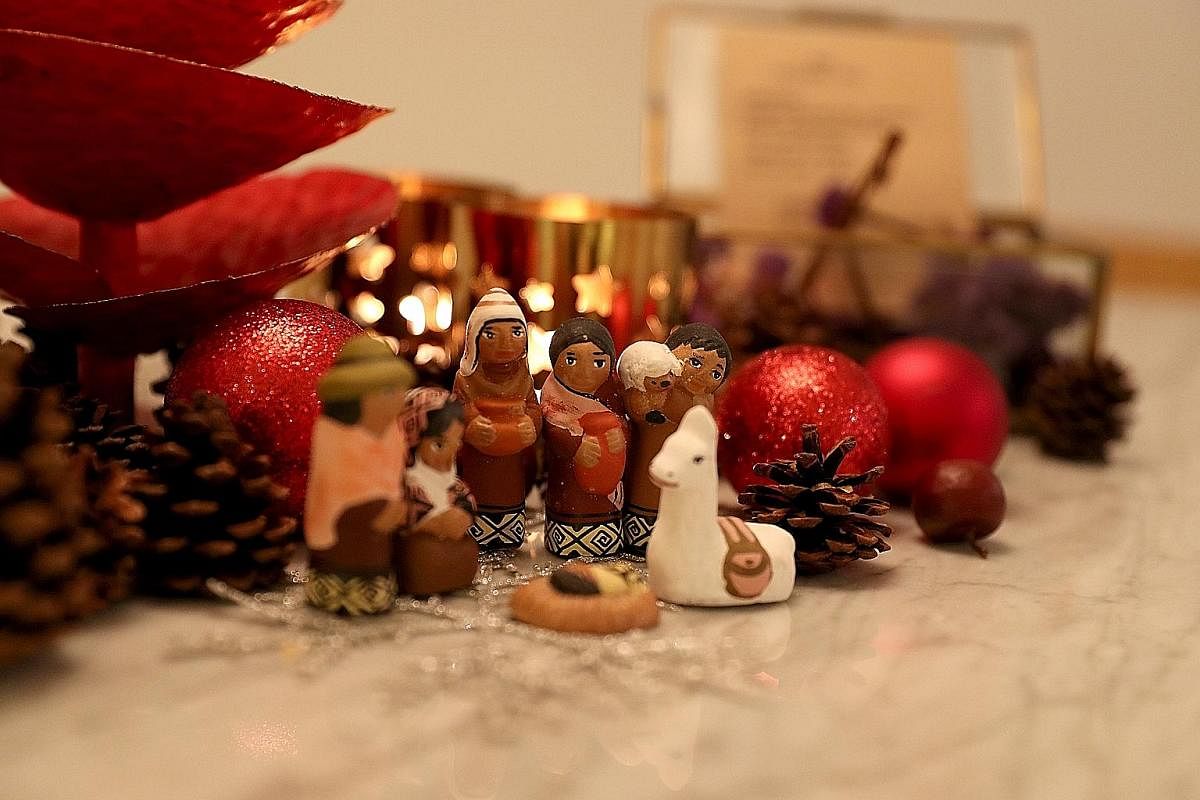 Ms Sharon Lee and her husband Christophe (above) host a Christmas party for about 50 friends every year. They set the mood with subtle touches, such as displaying miniature figures.