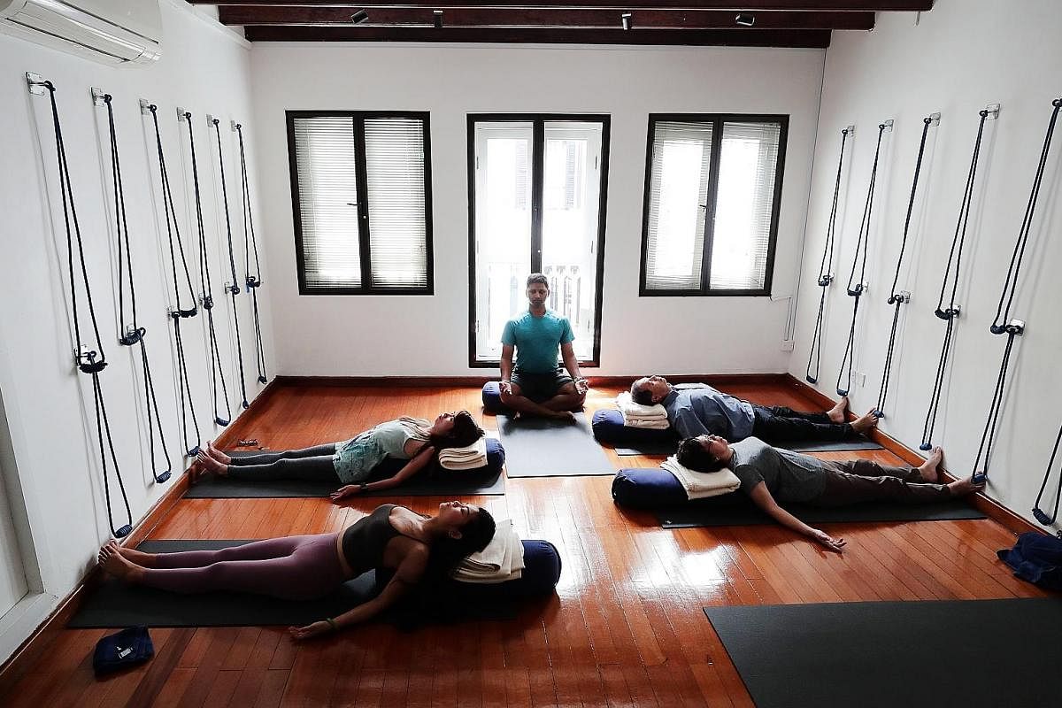 Mr Krishna Mohan (centre) leads a pranayama and meditation class at boutique fitness studio Level.