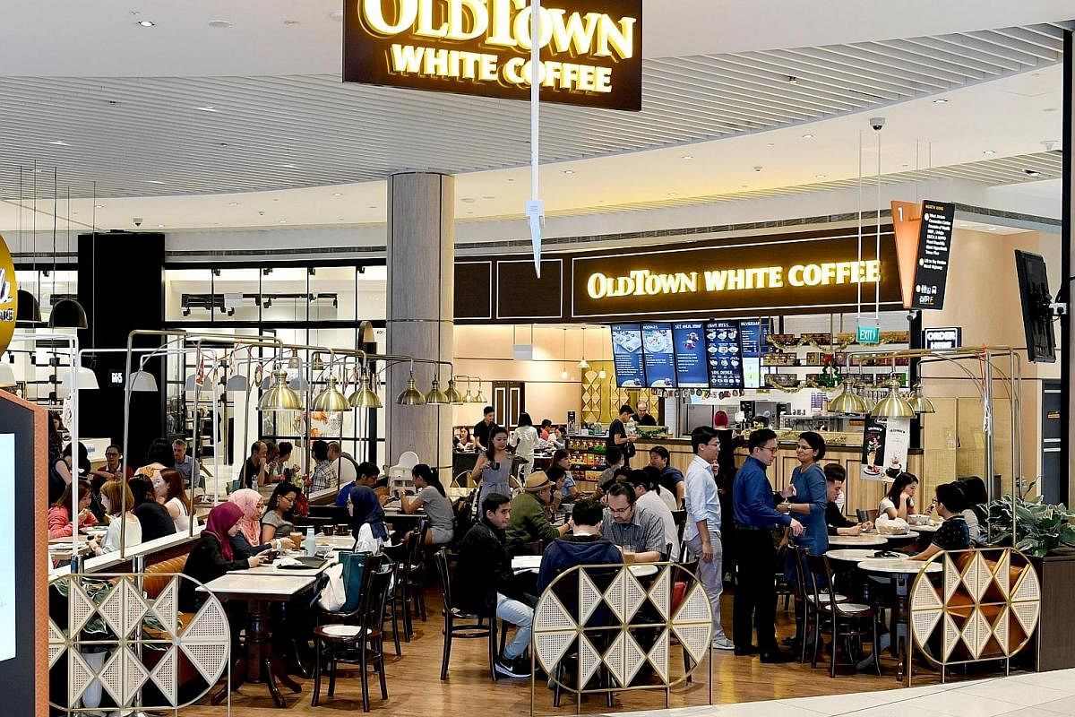 OldTown White Coffee's Suntec City outlet has a sleek look, with brass lights and textured light oak walls. (Above) Hideout by The Local Box at The Heeren has a minimalist look and its menu is an extension of The Local Box cafe's best-selling dishes.