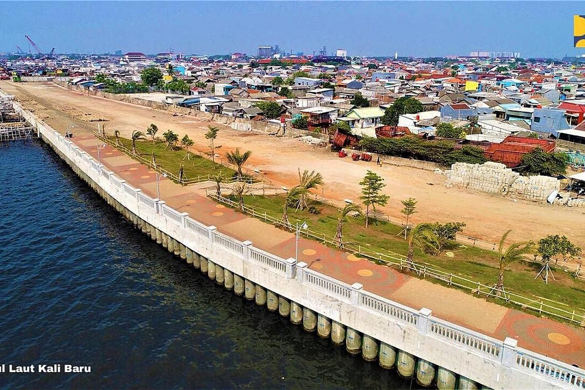 The coastal sea wall in Kali Baru, North Jakarta. The structure is part of the National Capital Integrated Coastal Development project to reduce coastal flooding in Jakarta. Above: An aerial view of the $55 billion land reclamation project in Jakarta
