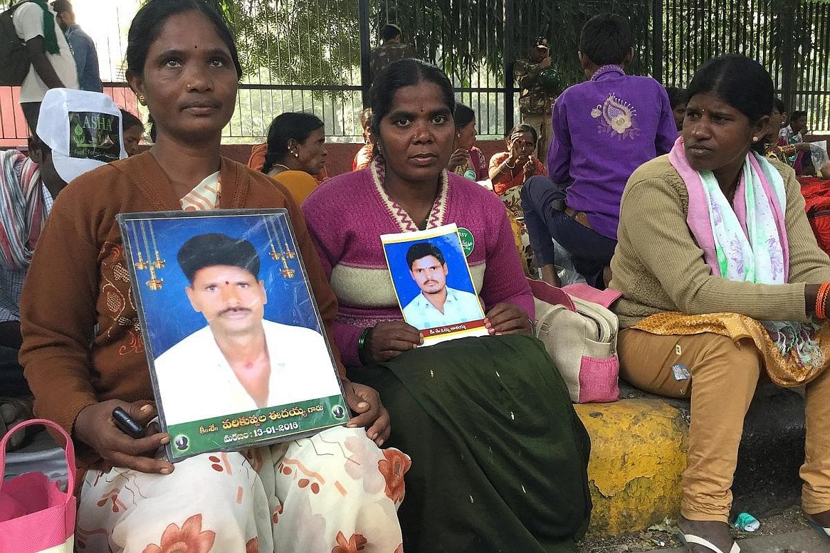 Above: Widows Idamma (left) and Kavitha, with photos of their farmer husbands who committed suicide, resting after a 3km walk at a New Delhi rally last month. Below: Tamil Nadu farmers came with bones and skulls of farmers who they claimed had commit
