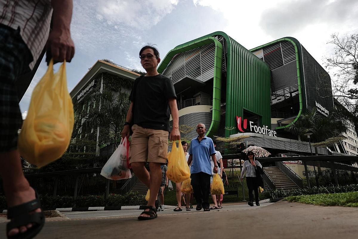 Left and top: Wet market stallholders at the Bukit Panjang Hawker Centre and Market have been given until April next year to decide whether to stay on after nearly three years of sluggish sales. Above: The wet market at the centre is on the second fl