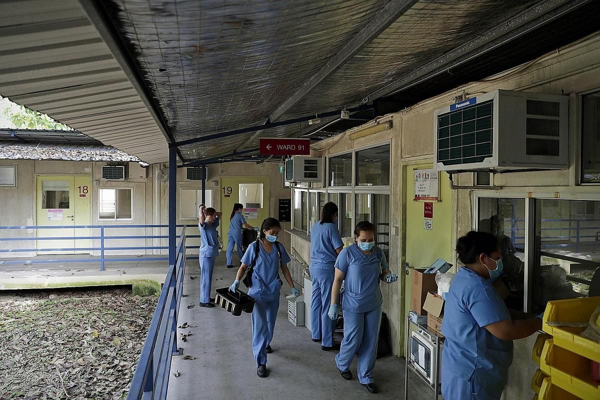 Nurses pack up the nursing station near the cabin rooms used by Sars patients. During the Sars outbreak in 2003, there was a shortage of isolation rooms in Tan Tock Seng Hospital and 80 cabin rooms were built using containers to isolate Sars patients.