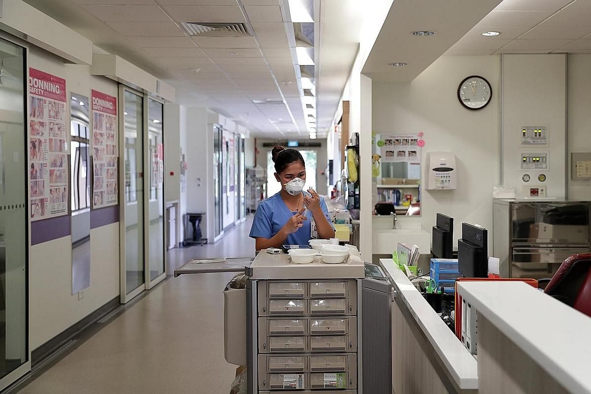  A nurse prepares medication for patients in the negative pressure wards, where airflow is controlled in a way that prevents contamination of hospital wards. 