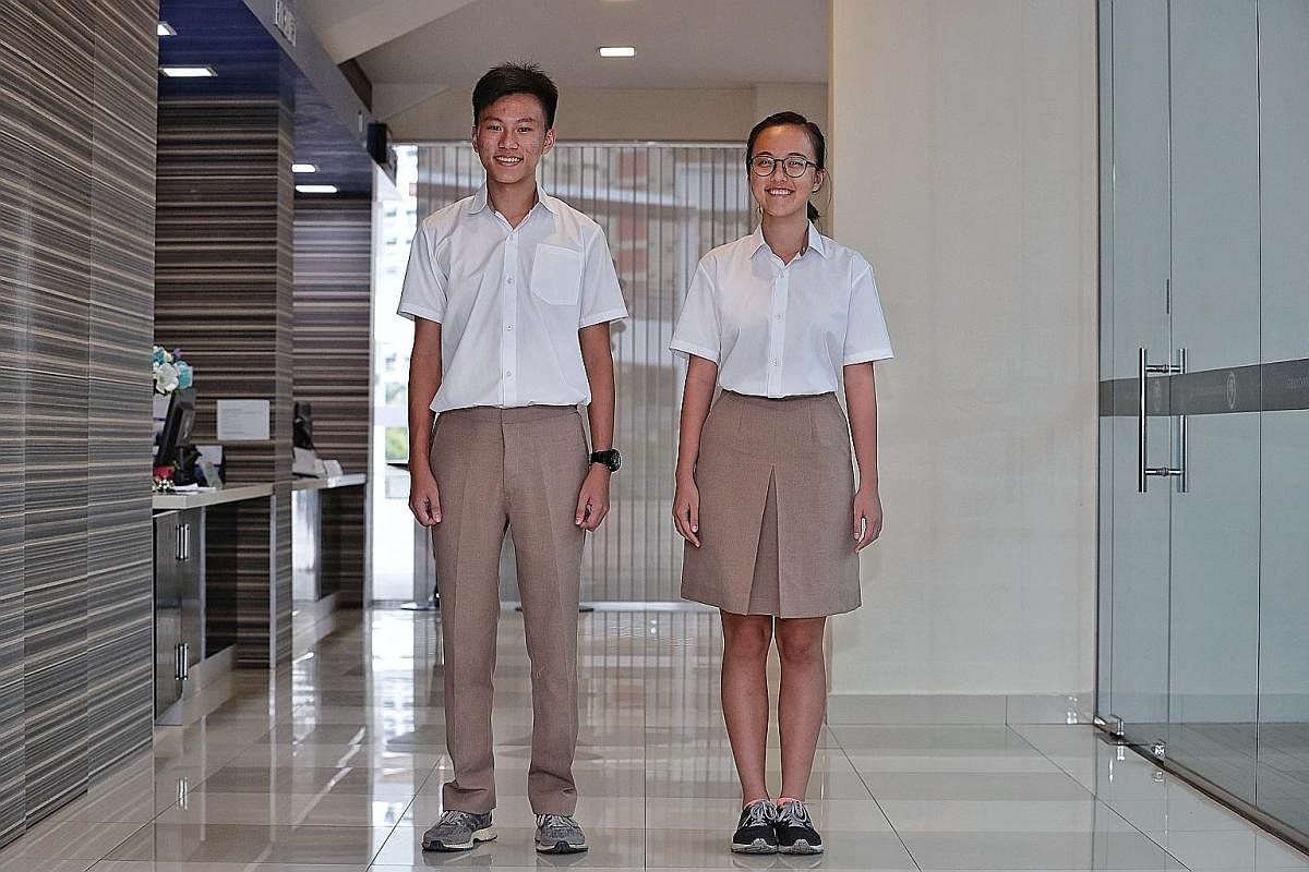 Jonathan Teo Jun Rui, 16, and Keesha Tan Kai Xuan, 17, of Tampines Meridian JC - one of the four merged schools - in their new uniforms.
